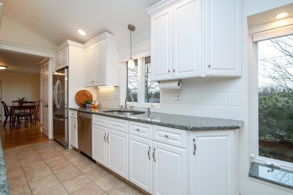 1110 Amostown Road West Springfield, MA 01089 - Photo 10 of 37 a kitchen with granite countertop white cabinets and white appliances