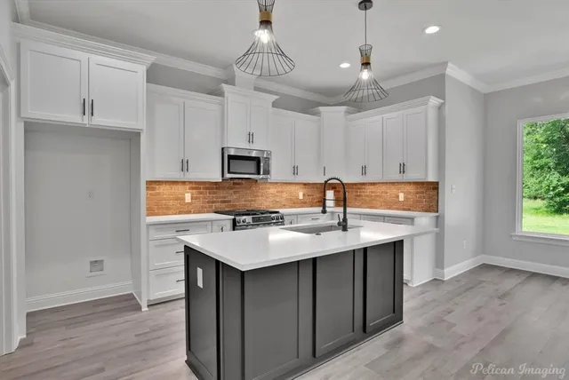 a view of a kitchen with a sink stainless steel appliances and cabinets