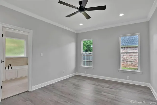 a kitchen with stainless steel appliances a sink a stove a refrigerator cabinets and a window