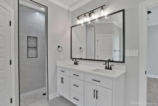 a kitchen with kitchen island granite countertop a sink a counter space appliances and cabinets