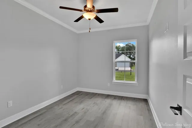 wooden floor in an empty room with a window
