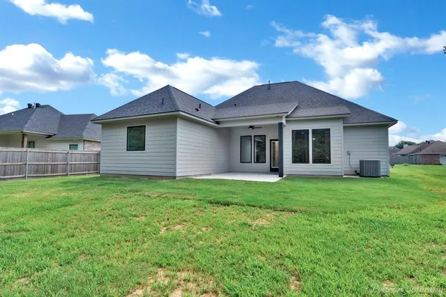 a bathroom with a sink a toilet a mirror and shower