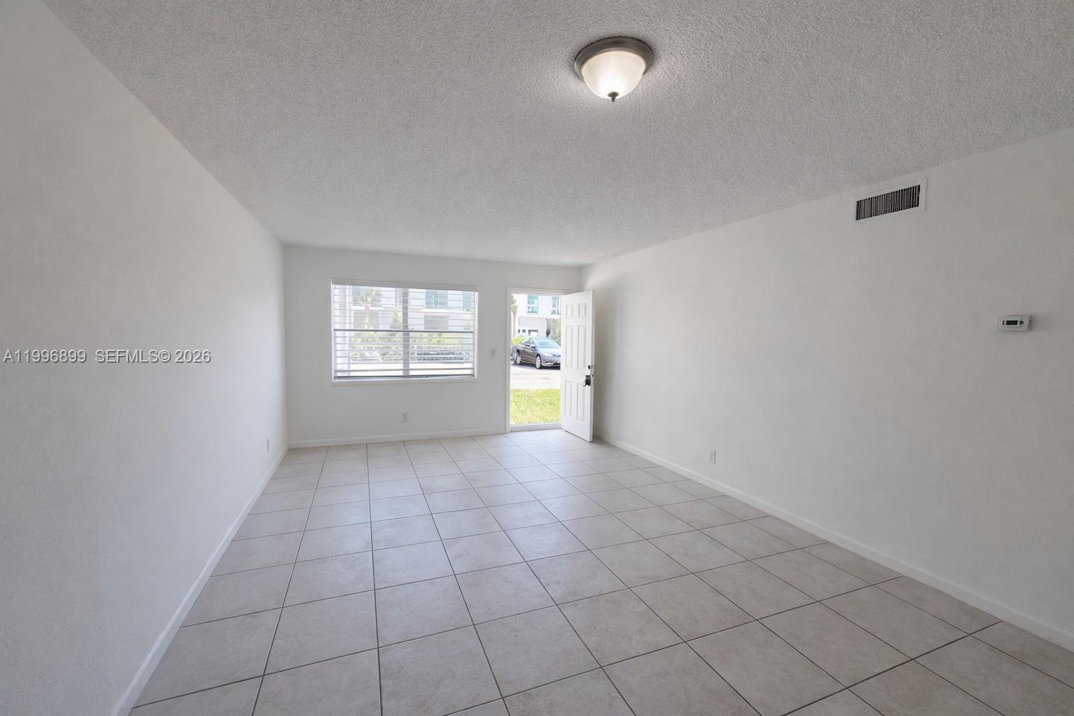 2521 Pierce Street, Unit 2 Hollywood, FL 33020 - Photo 3 of 11 an empty room with windows