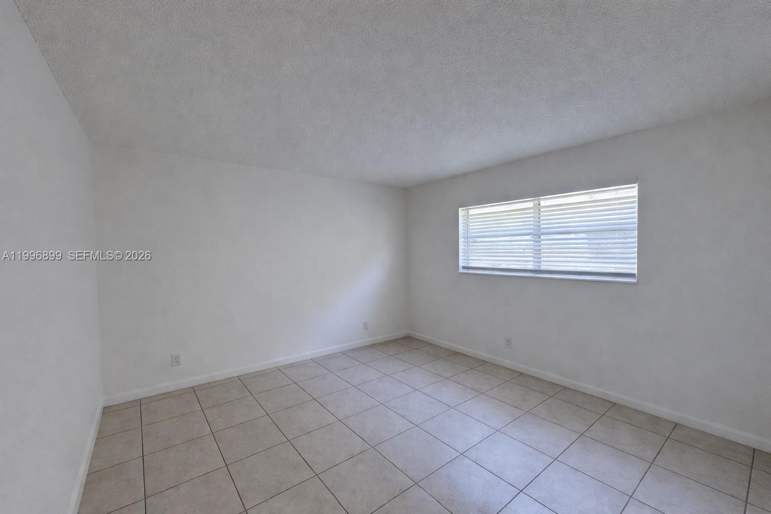 2521 Pierce Street, Unit 2 Hollywood, FL 33020 - Photo 5 of 11 a view of an empty room with a window