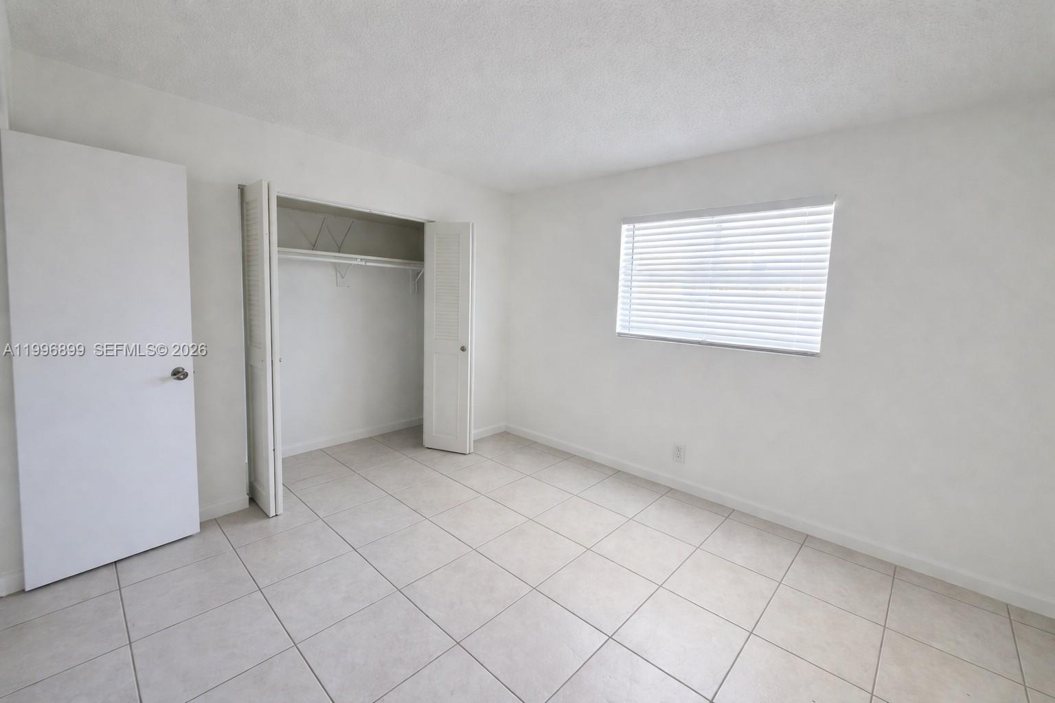 2521 Pierce Street, Unit 2 Hollywood, FL 33020 - Photo 8 of 11 an empty room with windows