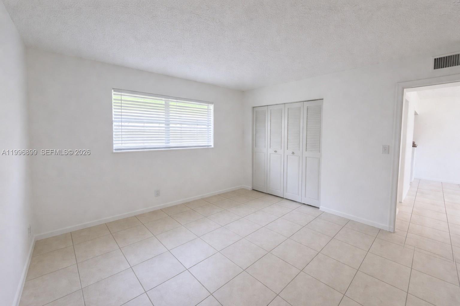 2521 Pierce Street, Unit 2 Hollywood, FL 33020 - Photo 9 of 11 an empty room with windows