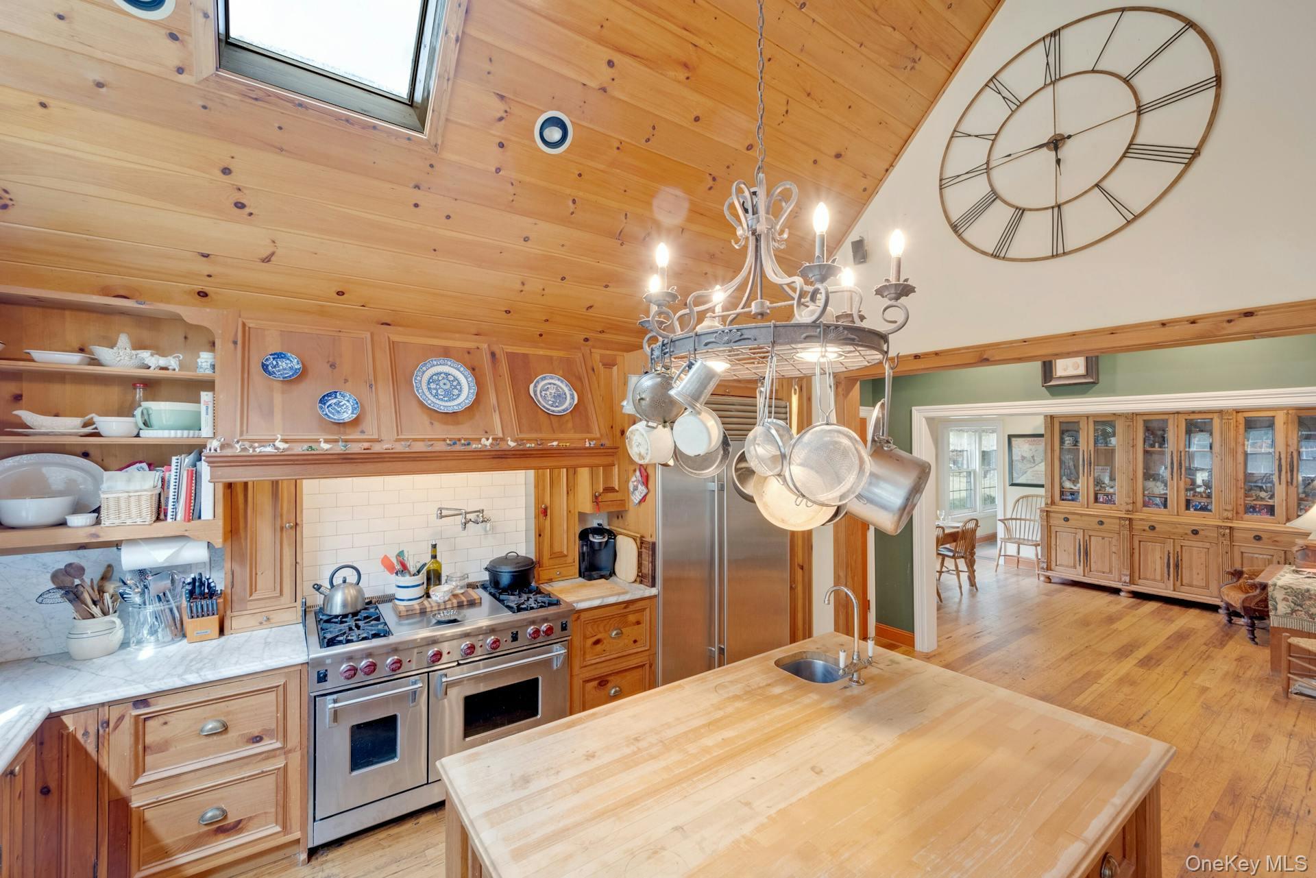 209 Hardscrabble Road North Salem, NY 10560 - Photo 12 of 40 a kitchen with stainless steel appliances kitchen island granite countertop a stove a sink a dining table and chairs with cabinets