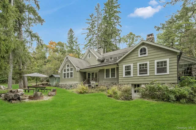 a view of a swimming pool with a yard and trees
