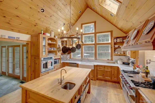 a kitchen with a sink a stove and a refrigerator