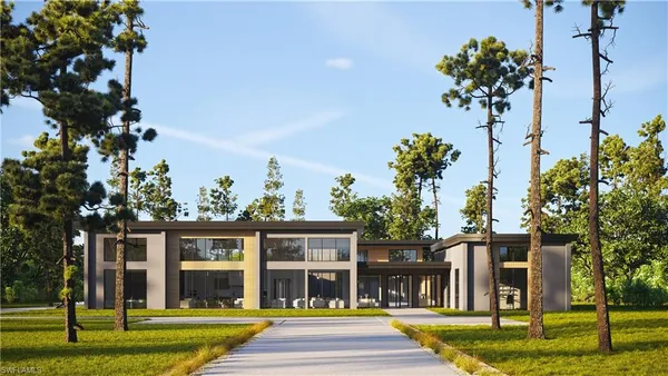 a view of a brick house with a big yard and large trees