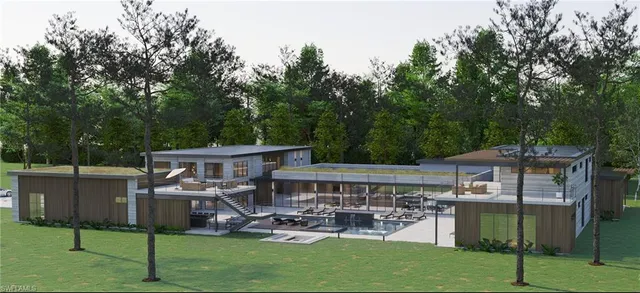 a view of a patio with table and chairs under an umbrella with large trees