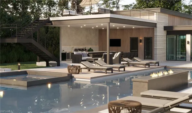 a view of a patio with table and chairs potted plants and large tree