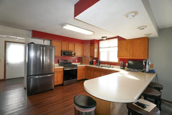 a view of water heater room with wooden floor