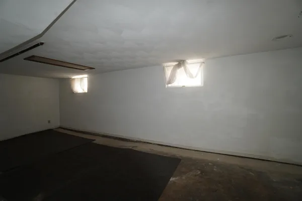 a room with a window and a wooden floor