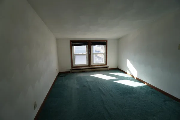 a living room with furniture a rug and a window