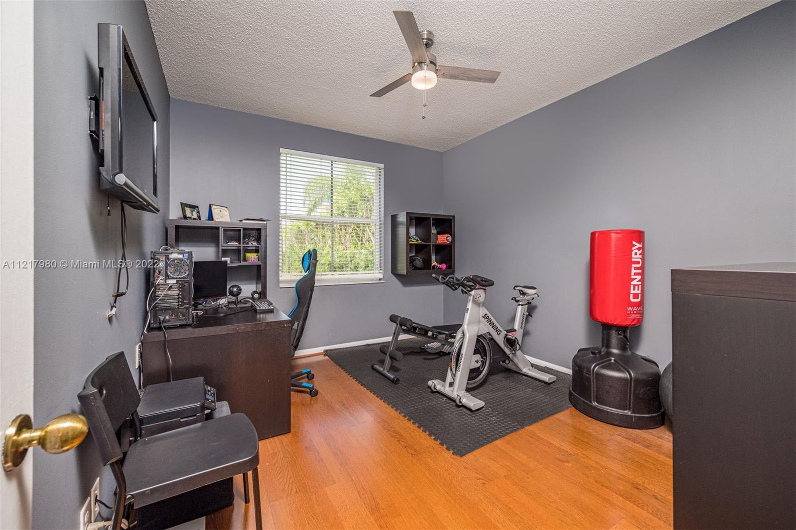 1418 Sandpiper Circle Weston, FL 33327 - Photo 11 of 31 a room with furniture a flat screen tv and a window