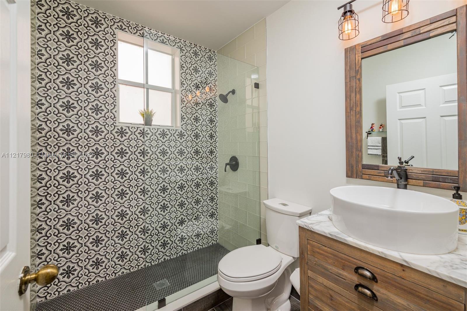 1418 Sandpiper Circle Weston, FL 33327 - Photo 12 of 31 a bathroom with a sink a toilet and shower