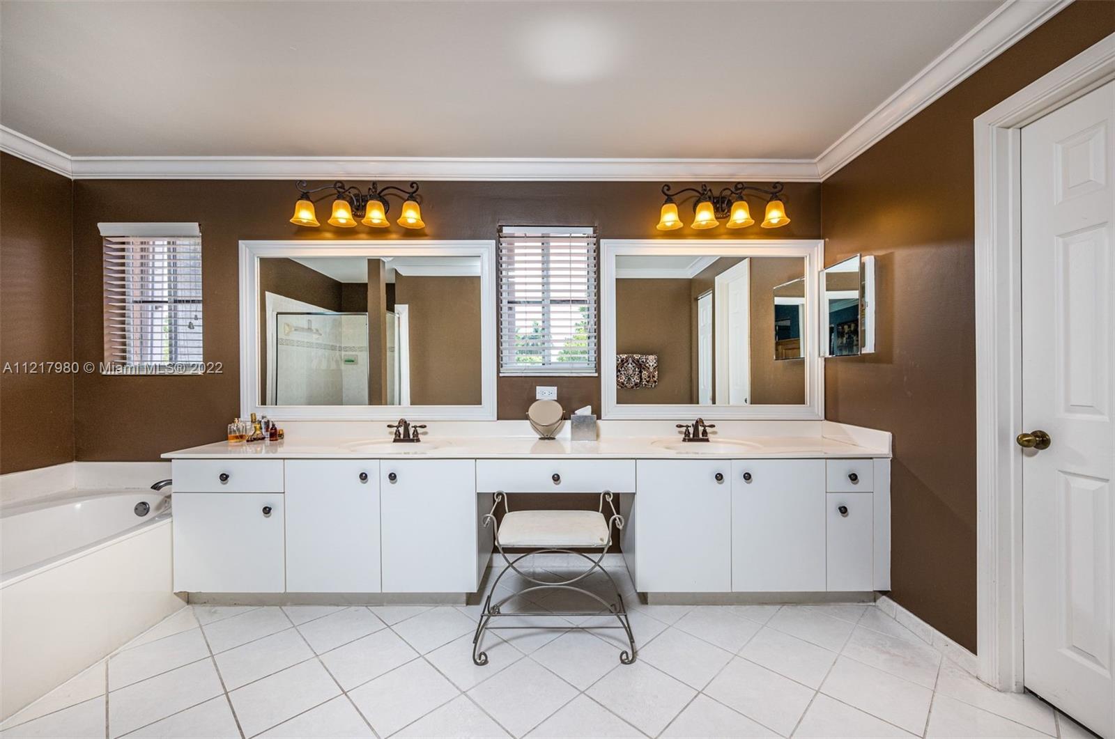 1418 Sandpiper Circle Weston, FL 33327 - Photo 15 of 31 a spacious bathroom with a double vanity sink and a mirror