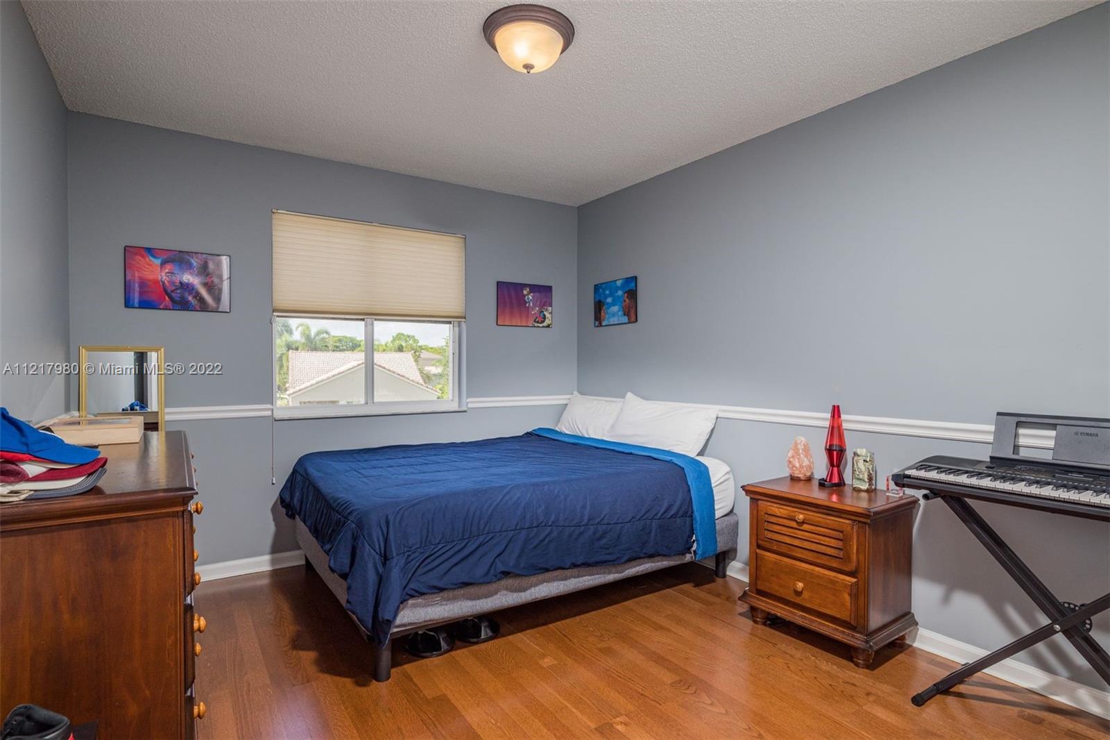 1418 Sandpiper Circle Weston, FL 33327 - Photo 17 of 31 a bedroom with a bed and a window