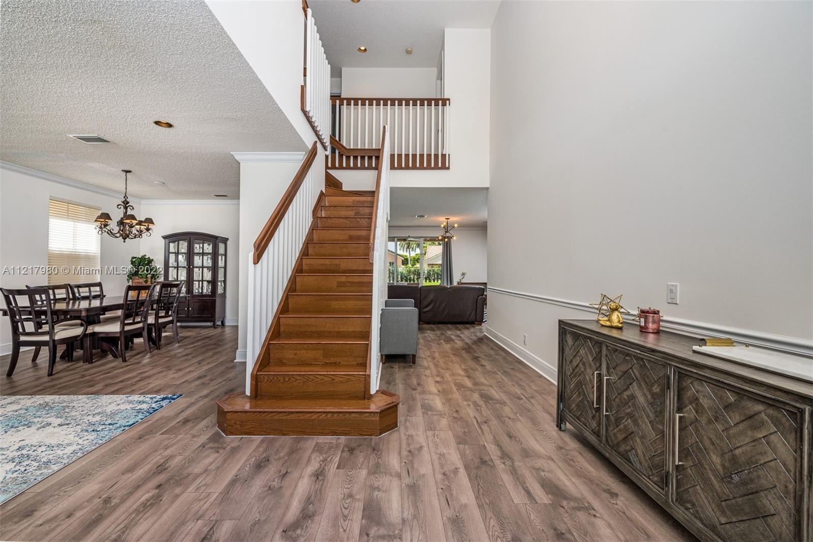 1418 Sandpiper Circle Weston, FL 33327 - Photo 2 of 31 a view of entryway and hall with wooden floor