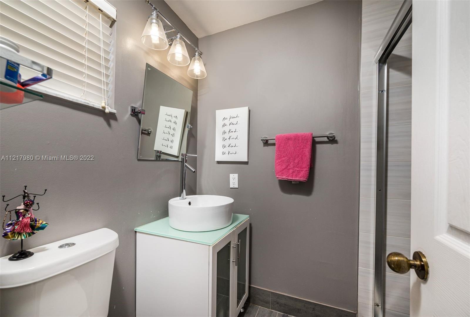 1418 Sandpiper Circle Weston, FL 33327 - Photo 22 of 31 a bathroom with a sink vanity mirror and toilet