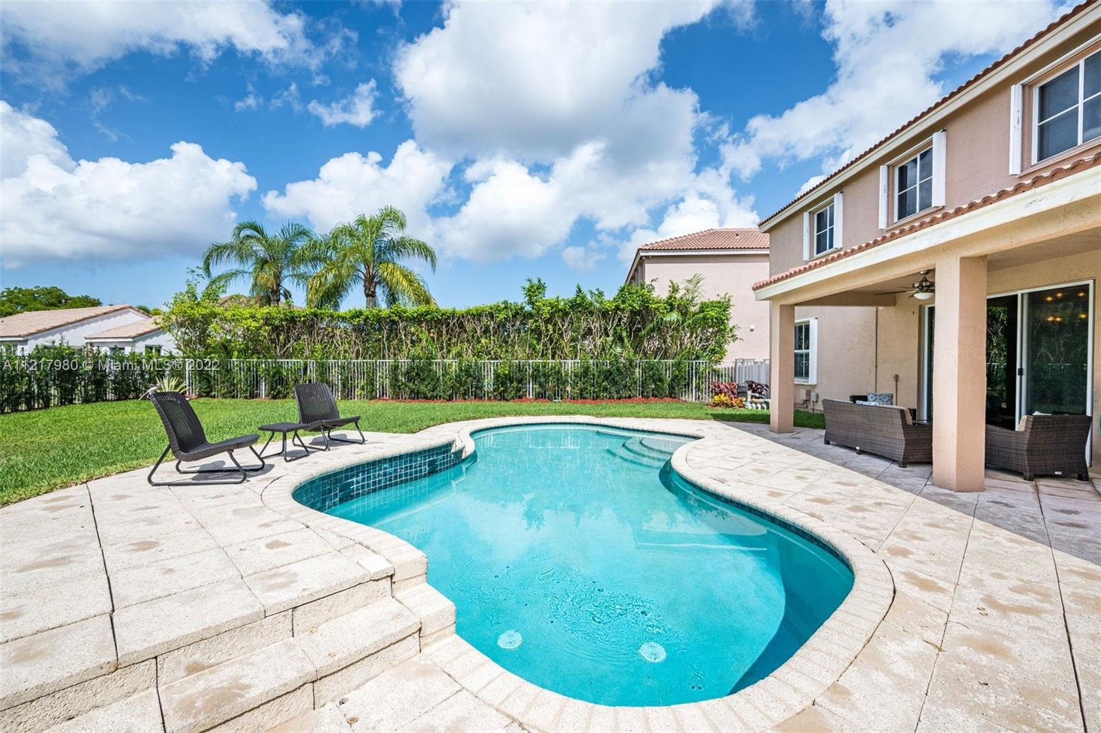 1418 Sandpiper Circle Weston, FL 33327 - Photo 27 of 31 a view of a house with swimming pool and sitting area