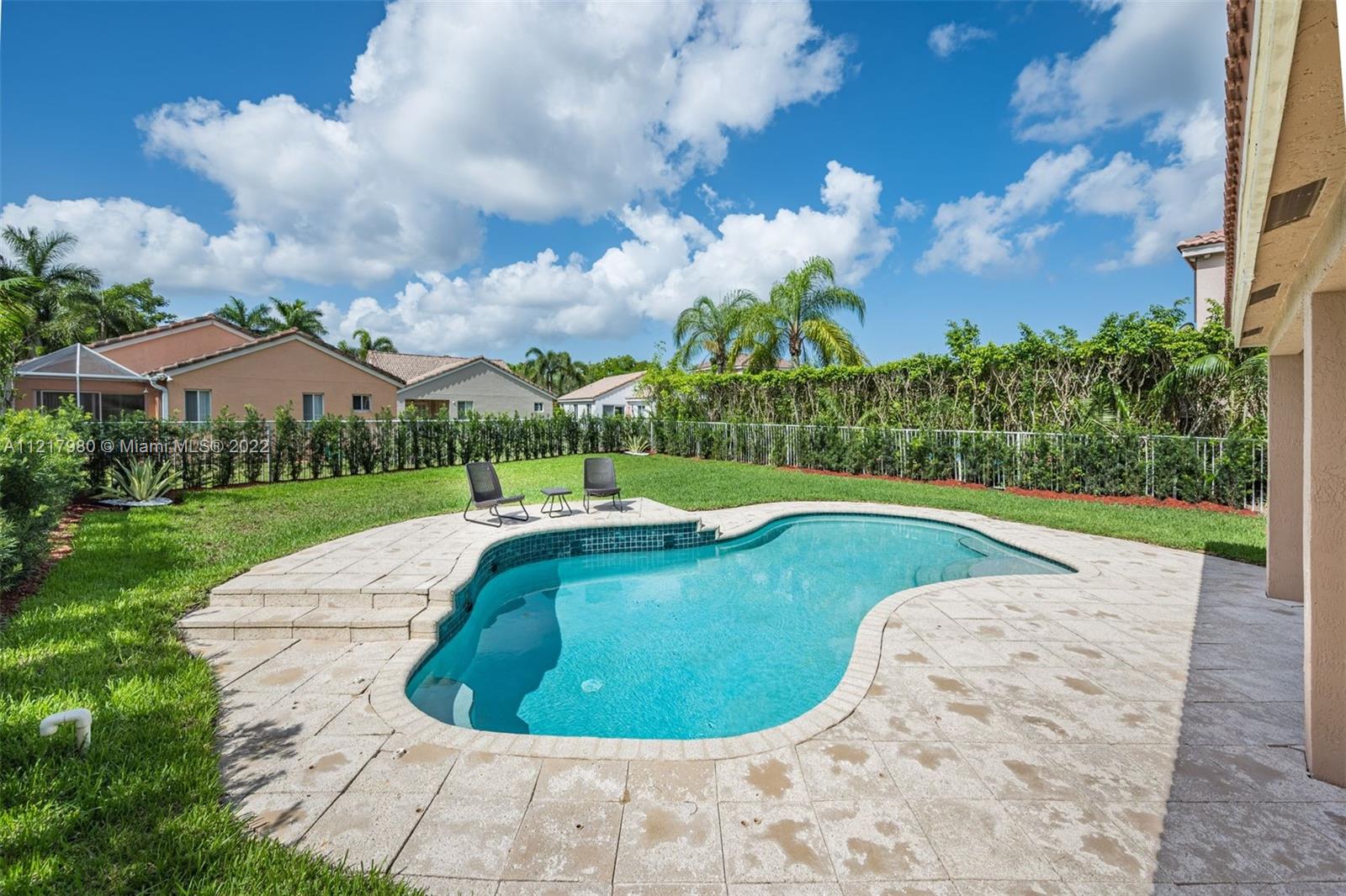 1418 Sandpiper Circle Weston, FL 33327 - Photo 28 of 31 a view of a swimming pool with a yard