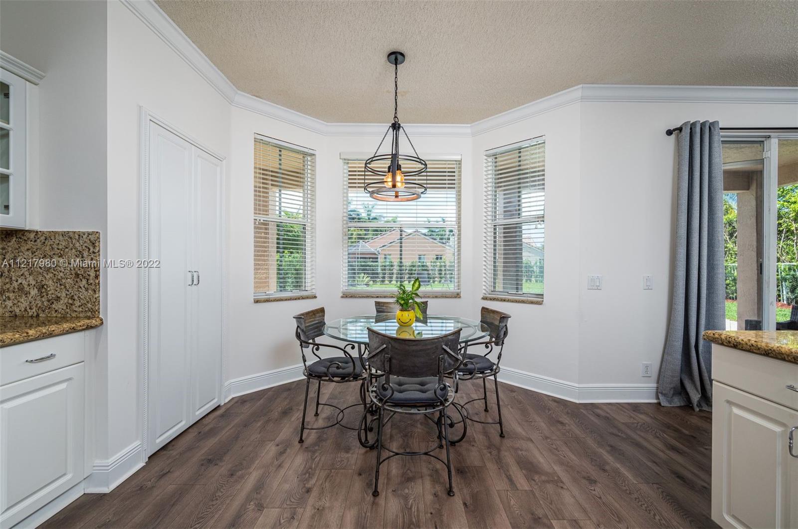 1418 Sandpiper Circle Weston, FL 33327 - Photo 8 of 31 a dining room with furniture window wooden floor