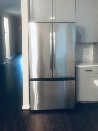 a view of a kitchen with wooden floor and a sink