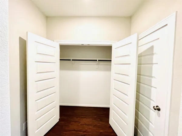 a view of walk in closet with empty racks