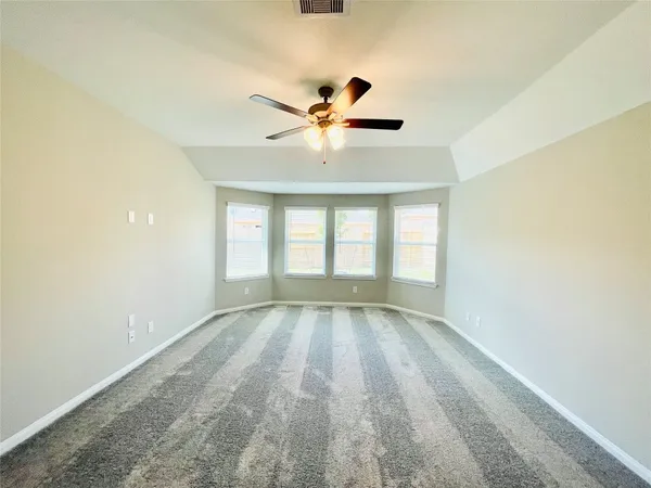 a spacious bathroom with a bathtub a double vanity sink and mirror