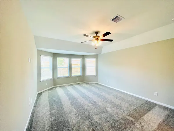 a spacious bathroom with a granite countertop tub a sink and a shower