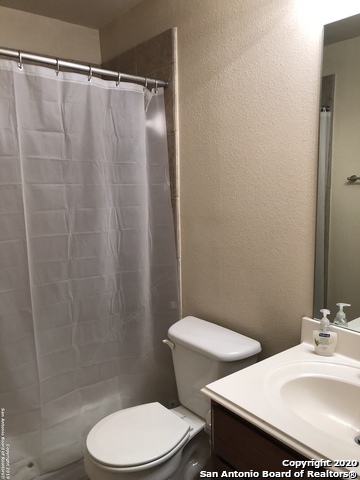 6802 Terra Rye San Antonio, TX 78240 - Photo 11 of 17 a white toilet sitting next to a bathroom sink