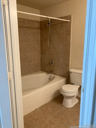 a bathroom with a toilet and a bathtub