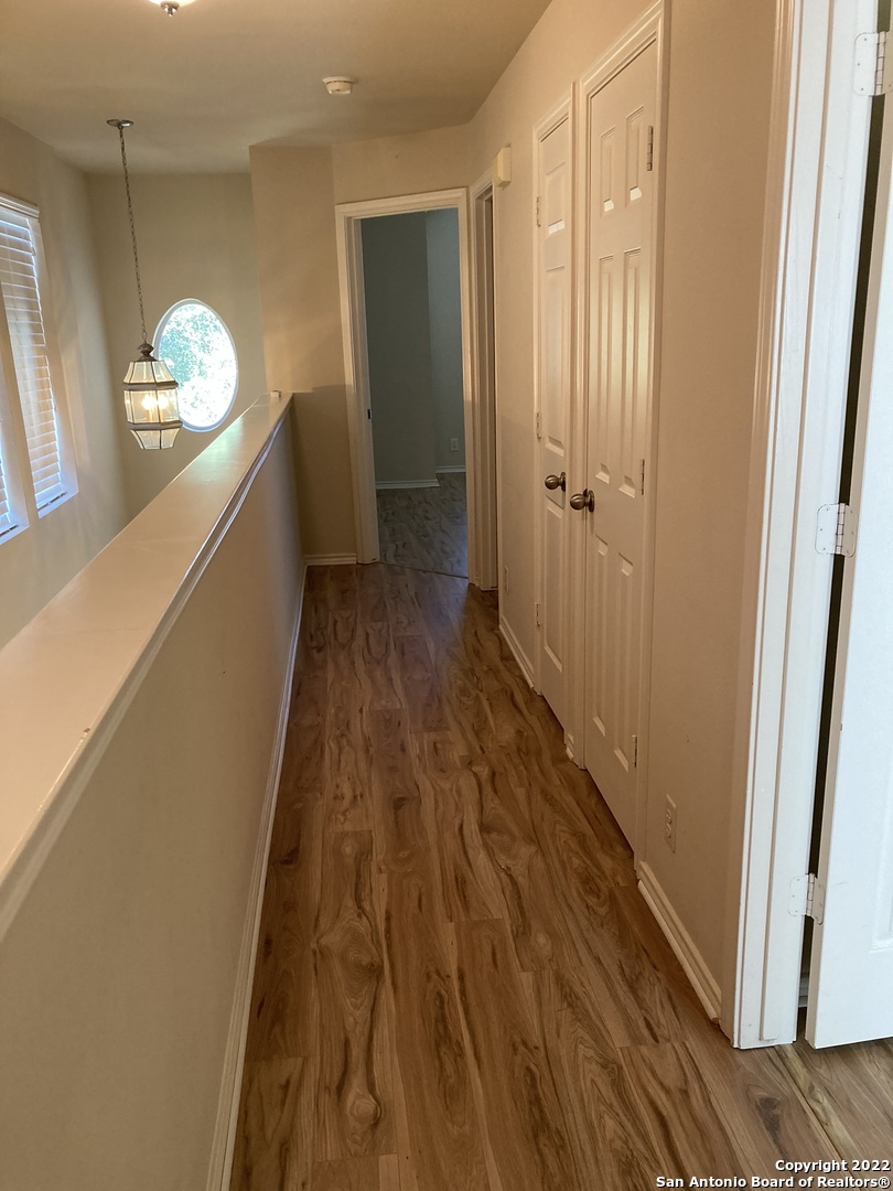 6802 Terra Rye San Antonio, TX 78240 - Photo 15 of 17 a room with wooden floor and staircase