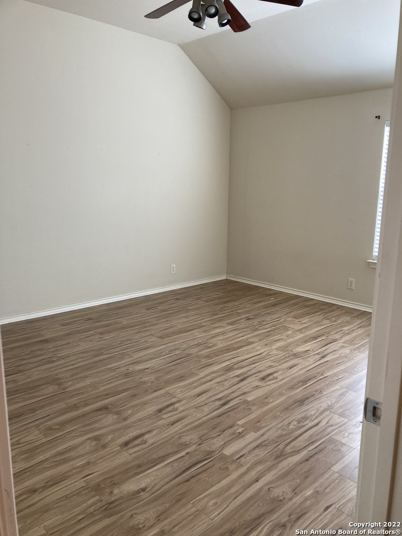 6802 Terra Rye San Antonio, TX 78240 - Photo 16 of 17 a view of an empty room with wooden floor