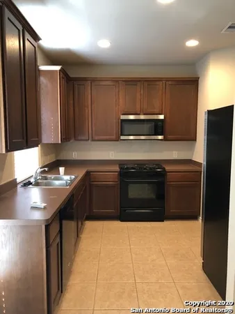 a kitchen with stainless steel appliances a sink stove and refrigerator