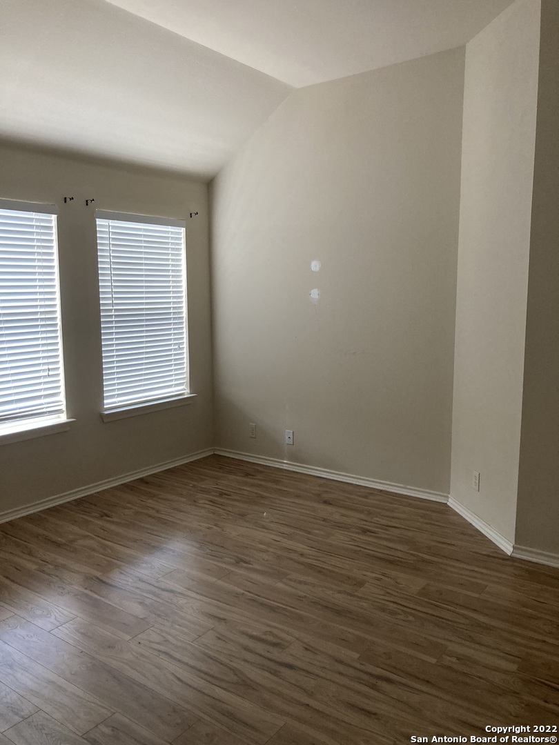 6802 Terra Rye San Antonio, TX 78240 - Photo 5 of 17 a view of an empty room with wooden floor and a window