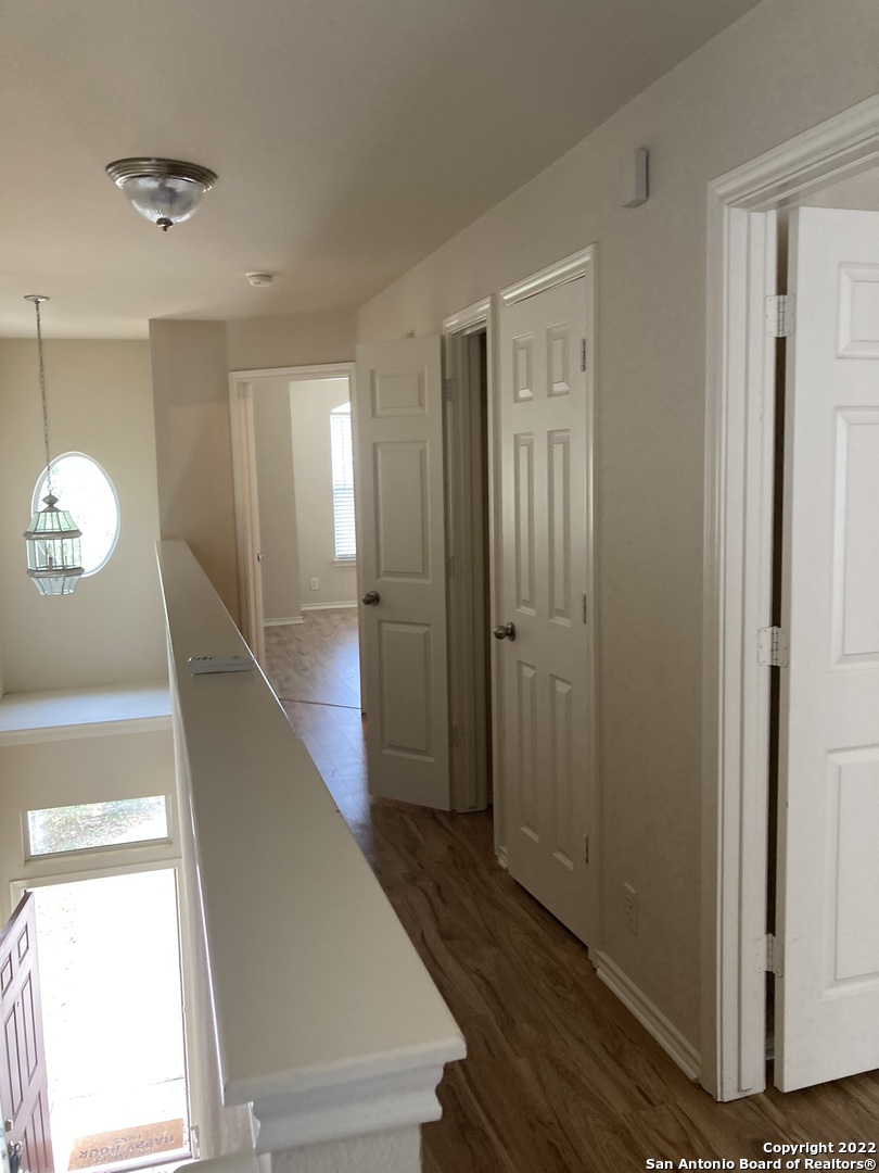 6802 Terra Rye San Antonio, TX 78240 - Photo 6 of 17 a view of a hallway with wooden floor and staircase