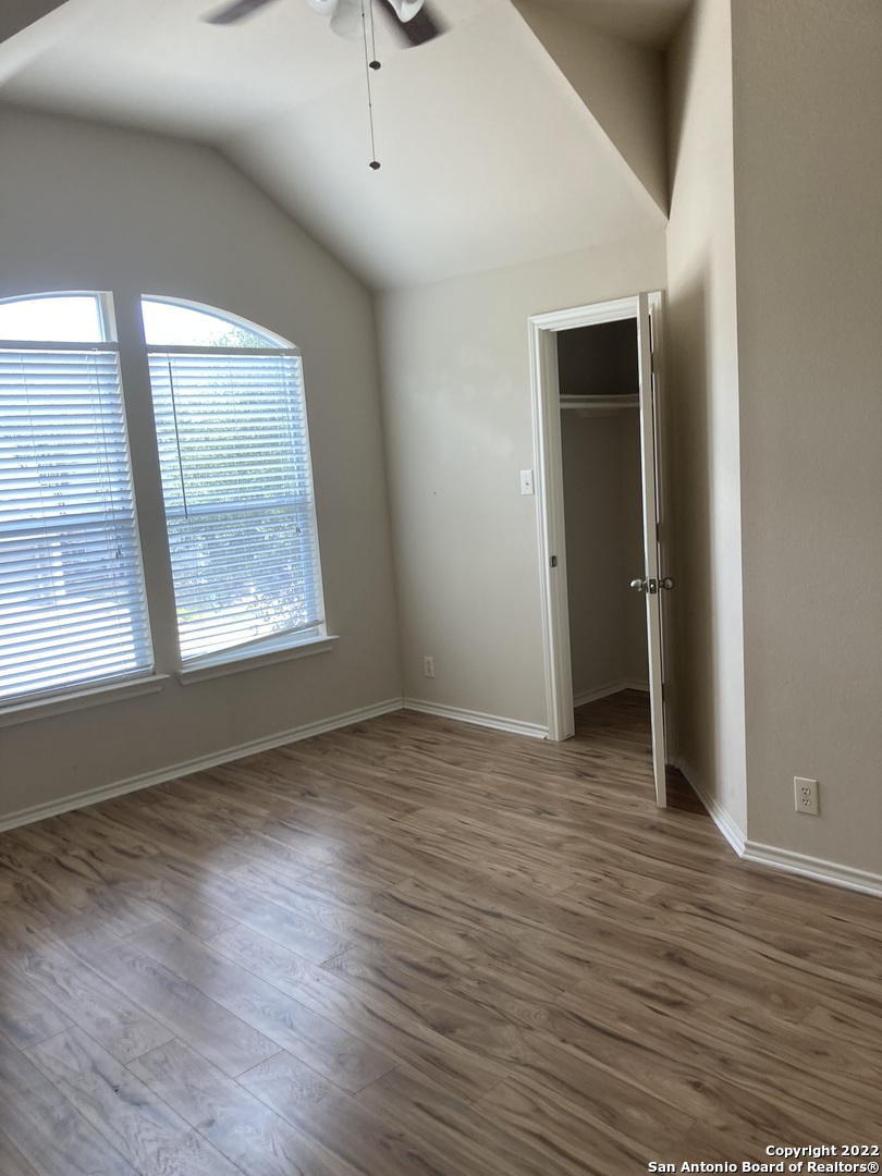 6802 Terra Rye San Antonio, TX 78240 - Photo 7 of 17 an empty room with wooden floor and windows
