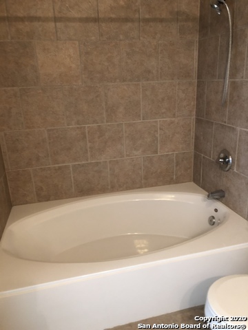 6802 Terra Rye San Antonio, TX 78240 - Photo 8 of 17 a bathroom with a bathtub and a shower