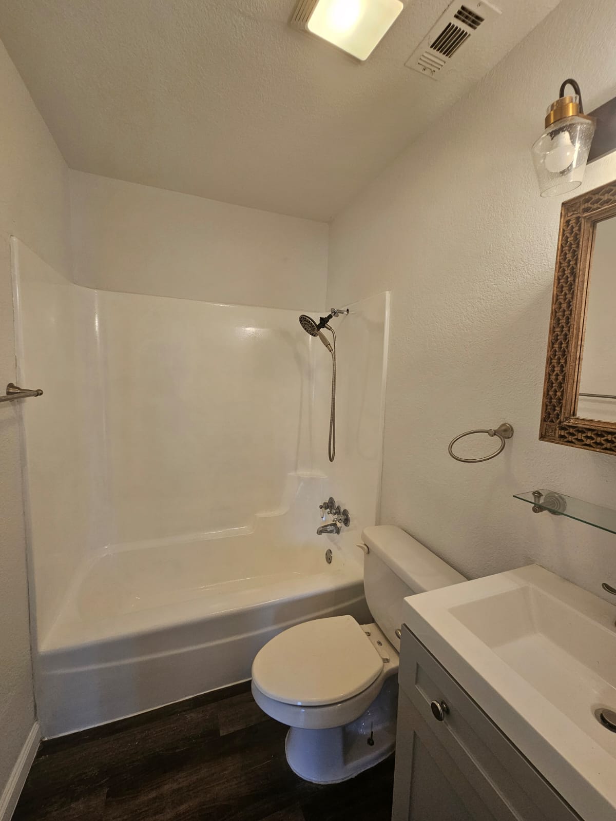 1401 Trinity Street Lockhart, TX 78644 - Photo 13 of 31 Bathroom featuring a white tub and shower combination with a handheld showerhead