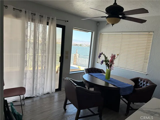a dining room with furniture and wooden floor