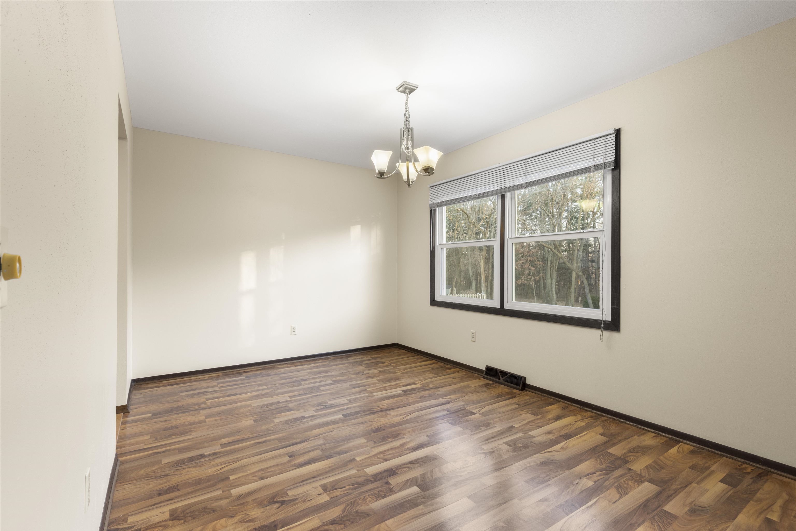 464 Valley Forge Trail Rockton, IL 61072 - Photo 5 of 24 an empty room with wooden floor chandelier and windows