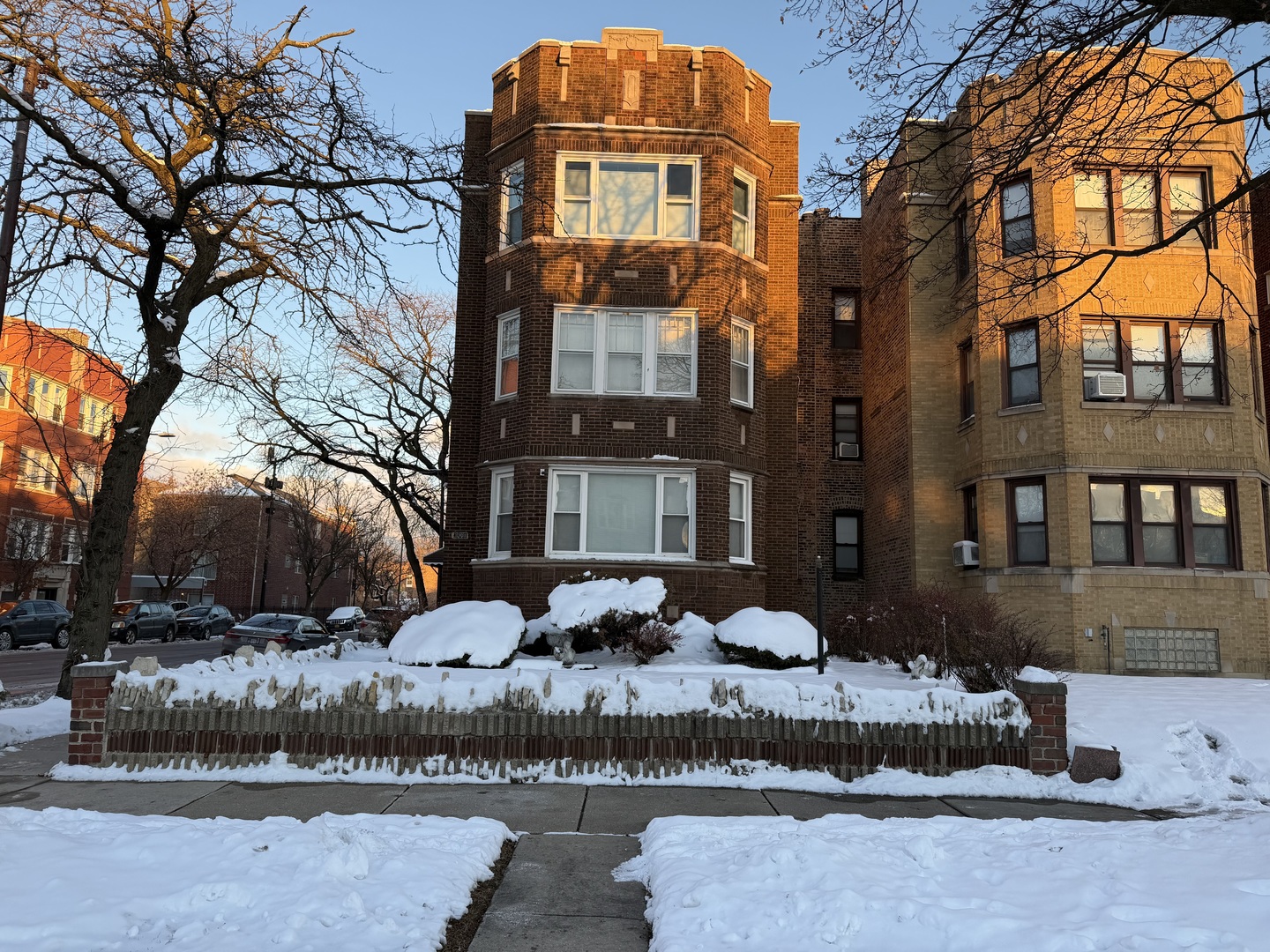 7301 South Constance Avenue, Unit 1 Chicago, IL 60649 - Photo 1 of 1 a front view of a residential apartment building with a yard