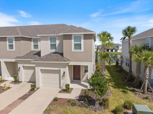 a front view of a house with a yard and garage