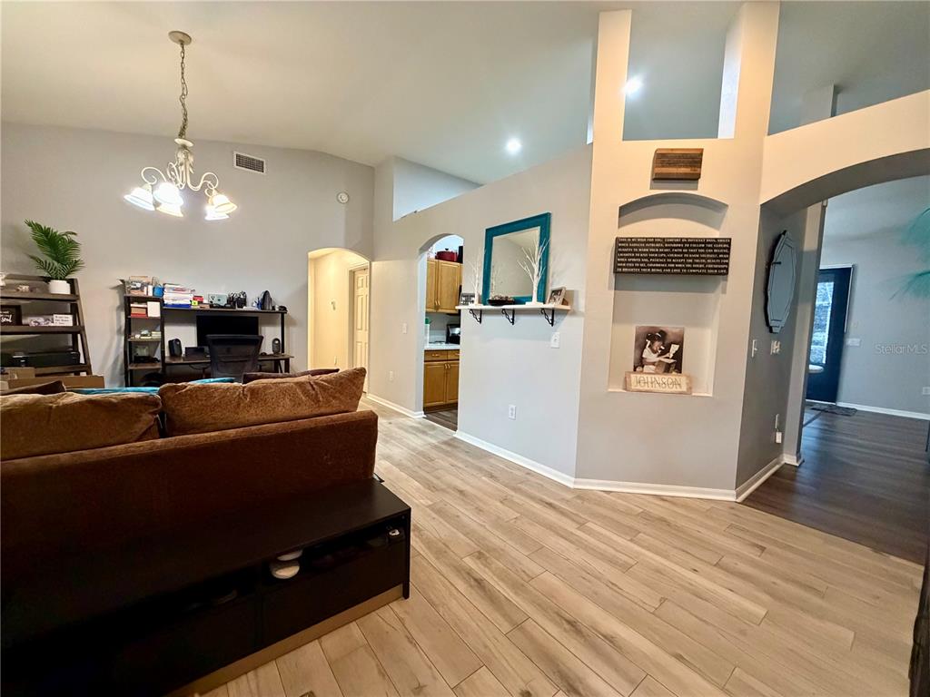 4303 Orange Ridge Court Valrico, FL 33596 - Photo 8 of 40 a living room with furniture wooden floor and a kitchen view