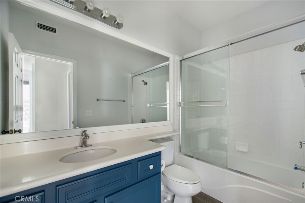 102 Roadrunner Irvine, CA 92603 - Photo 12 of 20 a bathroom with a granite countertop sink a toilet and shower