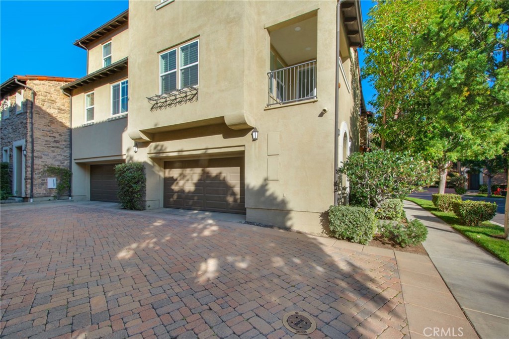 102 Roadrunner Irvine, CA 92603 - Photo 16 of 20 a front view of a house with a yard and a garage