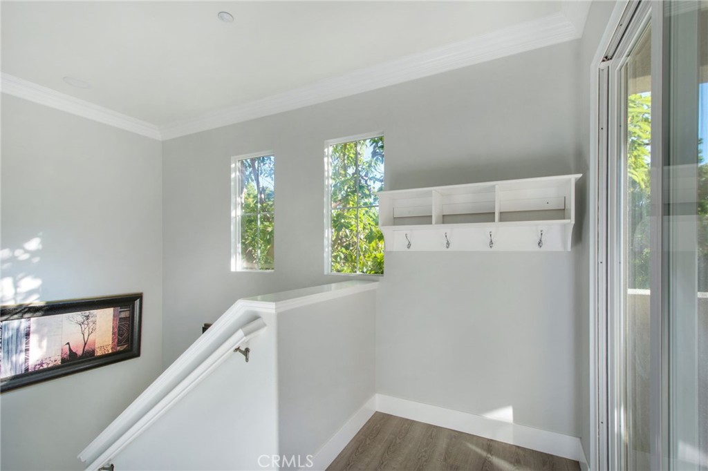 102 Roadrunner Irvine, CA 92603 - Photo 17 of 20 a view of a hallway with wooden floor and windows